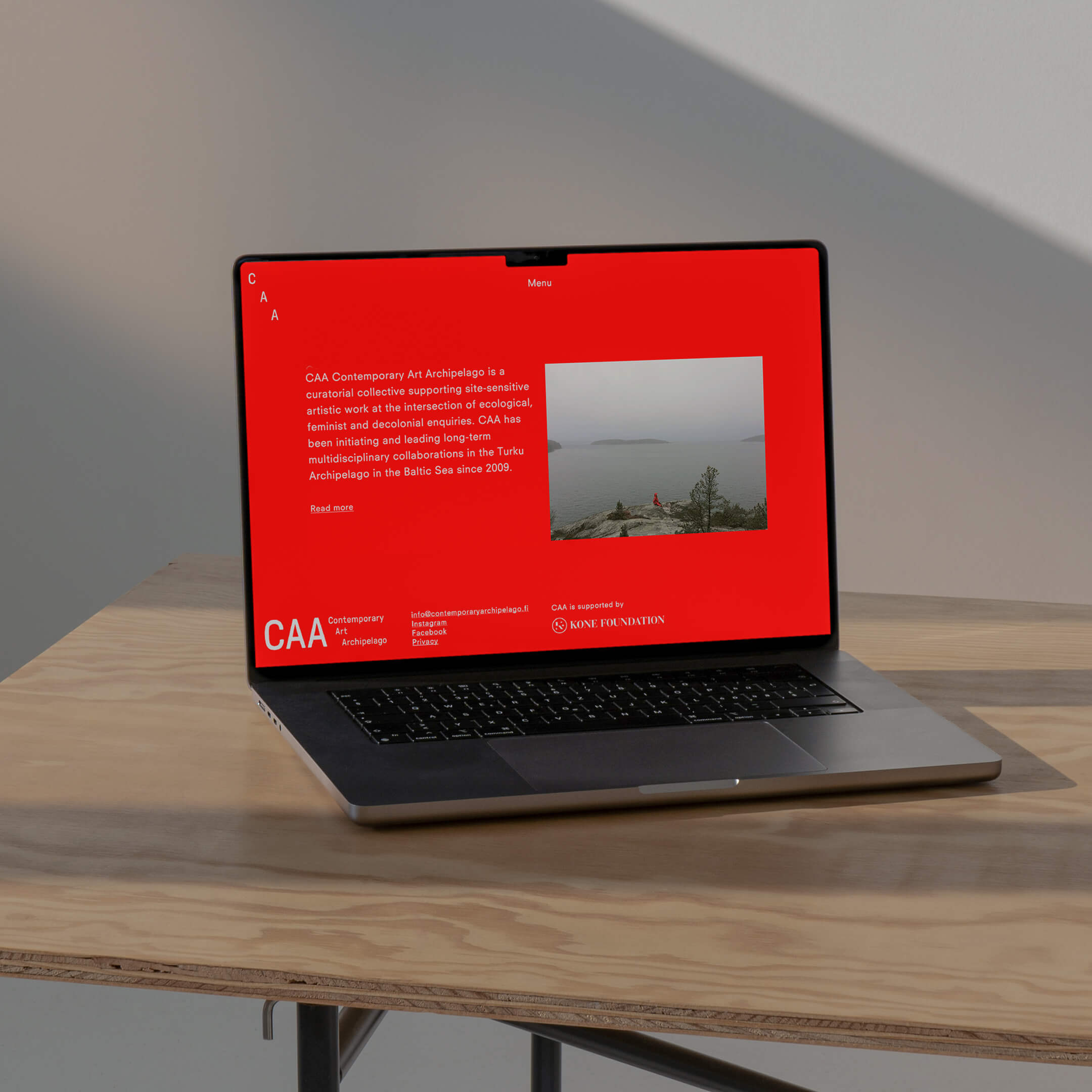 CAA–Contemporary Art Archpelago's website on a laptop on a table.