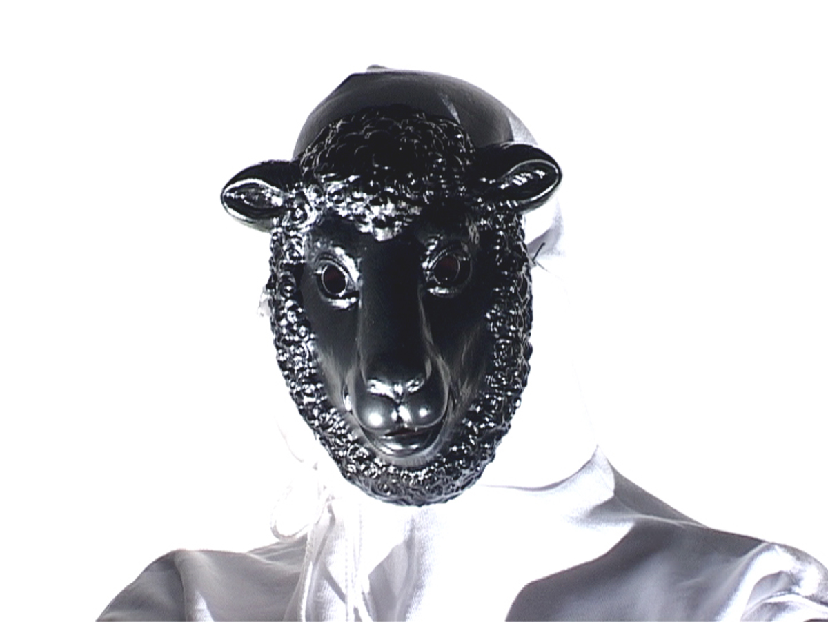 A person wearing white hoodie pullover and a black sheep mask.
